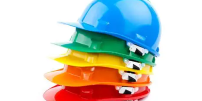Picture of differently colored hard hats stacked on top of each other